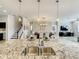 Open-concept kitchen with granite countertops and large island with view into the dining and living areas at 260 Teddy Rushing St, Debary, FL 32713