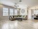 Bright living room with large windows, crown molding, ceiling fan, and luxury vinyl flooring at 260 Teddy Rushing St, Debary, FL 32713