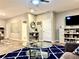 Comfortable living room with a glass coffee table, area rug, and a modern TV at 260 Teddy Rushing St, Debary, FL 32713