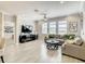 Bright living room featuring crown molding, a ceiling fan, and large windows for lots of natural light at 260 Teddy Rushing St, Debary, FL 32713