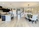 Open-concept living space boasts a modern kitchen with an island and a stylish dining area with contemporary light fixture at 260 Teddy Rushing St, Debary, FL 32713