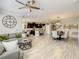 Open-concept living room showcasing luxury vinyl flooring with views of the kitchen and dining area at 260 Teddy Rushing St, Debary, FL 32713