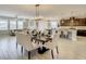 Open floor plan features modern living room, dining area, and kitchen with abundant natural light at 260 Teddy Rushing St, Debary, FL 32713