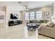 Bright living room featuring crown molding, a ceiling fan, and large windows for lots of natural light at 260 Teddy Rushing St, Debary, FL 32713