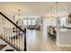 Open-concept living space with a staircase, dining area, living room and kitchen with island at 260 Teddy Rushing St, Debary, FL 32713