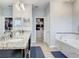 Bright main bathroom showcasing double sinks, walk-in closet, soaking tub, and modern fixtures at 260 Teddy Rushing St, Debary, FL 32713