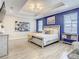 Main bedroom with blue accent wall and tray ceiling at 260 Teddy Rushing St, Debary, FL 32713
