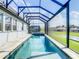 Beautiful covered pool and spa with views of the large backyard at 260 Teddy Rushing St, Debary, FL 32713