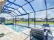 Stunning screened-in pool area with comfortable seating and a beautiful view of the backyard at 260 Teddy Rushing St, Debary, FL 32713