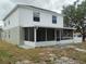 View of the home's screened-in porch and a spacious backyard at 2709 Sedgefield Ave, Deltona, FL 32725