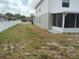 Spacious backyard featuring a white privacy fence and a screened-in lanai for outdoor enjoyment at 2709 Sedgefield Ave, Deltona, FL 32725