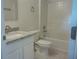 This bathroom is equipped with a granite vanity and a tiled shower-tub combination at 2709 Sedgefield Ave, Deltona, FL 32725