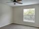 Cozy bedroom featuring plush carpet, ceiling fan, and a bright window with outdoor views at 2709 Sedgefield Ave, Deltona, FL 32725