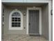 Inviting front door and arched window create a warm welcome to this home at 2709 Sedgefield Ave, Deltona, FL 32725