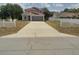 Charming two-story home with a concrete driveway and a lovely white picket fence at 2709 Sedgefield Ave, Deltona, FL 32725