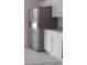 Stainless steel refrigerator complements the bright kitchen with white cabinets and granite countertops at 2709 Sedgefield Ave, Deltona, FL 32725
