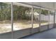 Enclosed lanai with views of the backyard and a white fence, perfect for relaxation at 2709 Sedgefield Ave, Deltona, FL 32725