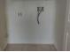 This laundry room features tile flooring, white walls, and hookups for a washer and dryer at 2709 Sedgefield Ave, Deltona, FL 32725