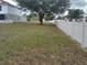 Large backyard with a large shade tree and partial vinyl fence at 2709 Sedgefield Ave, Deltona, FL 32725