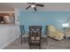 Open floorplan with kitchen and dining area, light blue walls, and gray wood floors at 2711 N Halifax Ave # 496, Daytona Beach, FL 32118