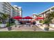 Community grilling area with picnic tables and red umbrellas outside of this condominium complex at 2711 N Halifax Ave # 496, Daytona Beach, FL 32118