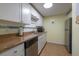 Galley kitchen features sleek stainless steel appliances, and granite countertops, offering modern convenience at 2711 N Halifax Ave # 496, Daytona Beach, FL 32118