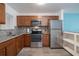This modern kitchen features stainless appliances, granite counters, and wood cabinets at 2711 N Halifax Ave # 496, Daytona Beach, FL 32118