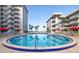 Enjoy this beautiful blue pool with palm trees and lounge chairs in a resort-style condominium setting at 2711 N Halifax Ave # 496, Daytona Beach, FL 32118