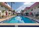 Community pool is surrounded by buildings, palm trees, and lounge chairs at 2711 N Halifax Ave # 496, Daytona Beach, FL 32118