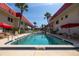 Community pool is surrounded by buildings, palm trees, and lounge chairs at 2711 N Halifax Ave # 496, Daytona Beach, FL 32118