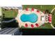 Aerial view of the outdoor pool with red umbrellas and plenty of lounge chairs at 2711 N Halifax Ave # 496, Daytona Beach, FL 32118