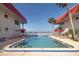 Outdoor pool with patio furniture and palm trees overlooking the water at 2711 N Halifax Ave # 496, Daytona Beach, FL 32118