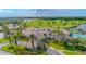 Aerial view of beautiful building overlooking lush golf course, lake, and pool with well-maintained landscaping at 276 Gala Cir, Daytona Beach, FL 32124