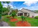 Serene backyard featuring a screened-in porch, lush green lawn, and mature trees for ultimate relaxation at 276 Gala Cir, Daytona Beach, FL 32124
