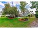 Beautiful backyard featuring a screened lanai, lush lawn, and mature landscaping at 276 Gala Cir, Daytona Beach, FL 32124
