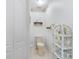 Small powder room features a toilet and a shelf with a decorative shelf at 276 Gala Cir, Daytona Beach, FL 32124