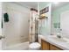 Standard bathroom with tub, shower and oak vanity, featuring neutral tones at 276 Gala Cir, Daytona Beach, FL 32124