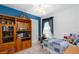 Cozy bedroom with blue accent wall, ceiling fan and built-in bookshelf at 276 Gala Cir, Daytona Beach, FL 32124
