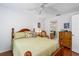 This bedroom has a hardwood floor, ceiling fan and leads to an ensuite bath at 276 Gala Cir, Daytona Beach, FL 32124