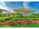 Beautiful building with tiled roof, manicured landscaping, and tropical flowers in a well-maintained community at 276 Gala Cir, Daytona Beach, FL 32124