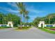 Welcoming LPGA International entrance with beautiful landscaping and palm trees under a clear blue sky at 276 Gala Cir, Daytona Beach, FL 32124