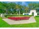 Manicured LPGA International entrance featuring colorful flower beds and fountain under sunny skies at 276 Gala Cir, Daytona Beach, FL 32124