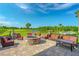 Inviting outdoor fire pit area with comfortable seating, perfect for relaxing by the lake and golf course at 276 Gala Cir, Daytona Beach, FL 32124