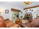 Cozy living room features tile flooring, a ceiling fan, and sliding glass doors to the outside patio at 276 Gala Cir, Daytona Beach, FL 32124