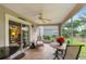 Cozy screened lanai featuring tile flooring, comfortable seating, and a view of the yard at 276 Gala Cir, Daytona Beach, FL 32124