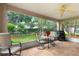 Relaxing screened lanai with ceiling fan, tile floor, and views of the well-maintained backyard at 276 Gala Cir, Daytona Beach, FL 32124