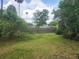 A fenced backyard with a green lawn at 2810 Kumquat Dr, Edgewater, FL 32141