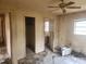 This bedroom features a ceiling fan and natural light from the windows at 2810 Kumquat Dr, Edgewater, FL 32141