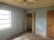 Bedroom with blue walls, one window, closet and laminate floors needing renovation at 2810 Kumquat Dr, Edgewater, FL 32141