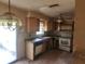 Kitchen with laminate countertops, appliances, ceiling fan and dated cabinets at 2810 Kumquat Dr, Edgewater, FL 32141
